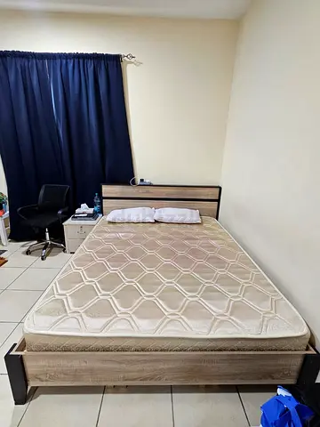 Queen size bed with mattress and side table