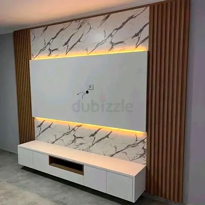 Modern wall-mounted TV entertainment unit with marble finish and LED lighting