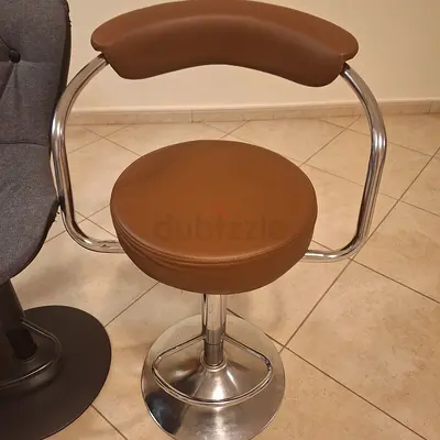 Brown leather swivel bar stool with chrome base — good condition