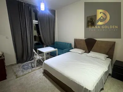 Available today in Dubai Warsan 4 studio with balcony, gym, and parking. Furnished with hotel-style furniture.