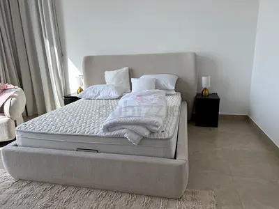 Modern Beige Fabric Upholstered Queensized Bed Frame with Storage and Mattress and sidetables.