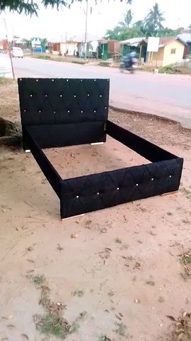 Queen-size black upholstered bed frame with tufted headboard