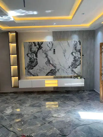 Modern wall-mounted TV unit with marble feature and floating cabinets