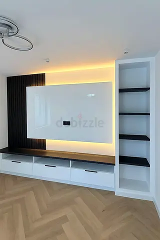 Custom built-in entertainment unit with LED backlighting and shelving