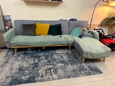 Light grey fabric sectional sofa with chaise, wooden legs - good condition can be converted to a bed
