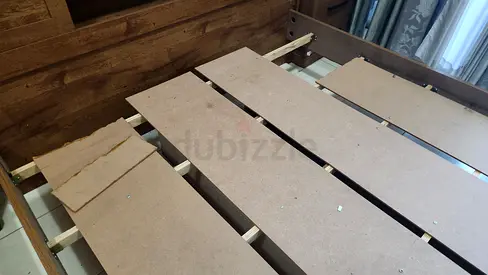 Kind wooden bed frame with headboard — needs slats replaced