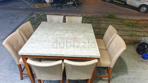 Solid wood dining table with marble top and 8 upholstered chairs - good condition