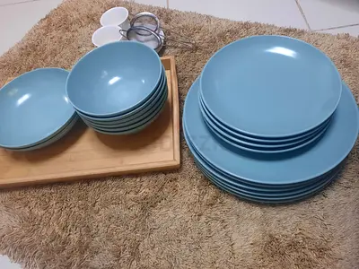 Ikea plates and bowls with a wooden tray and coffee cups