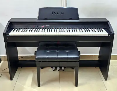 The Casio Privia PX-750 is an 88-key digital home piano featuring a furniture-style cabinet, a built