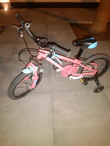 Kids pink 12-inch bicycle with training wheels - good condition