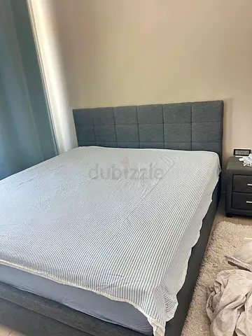 Grey upholstered double bed with padded headboard - and mattress good condition