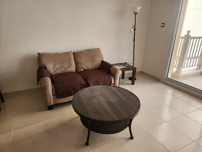 Two-seater sofa and round coffee table - good condition