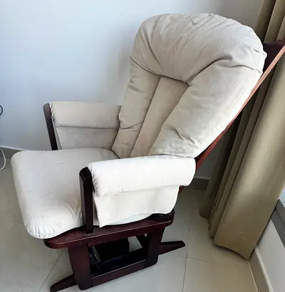 Beige padded wooden glider/rocking armchair in good condition