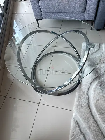 Round glass coffee table with chrome ring base
