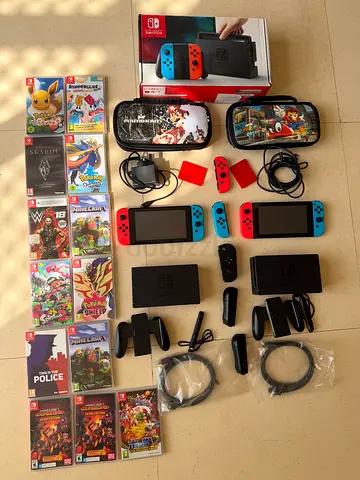 Two Nintendo Switch consoles with docks, controllers, cases and 16 games - bundle
