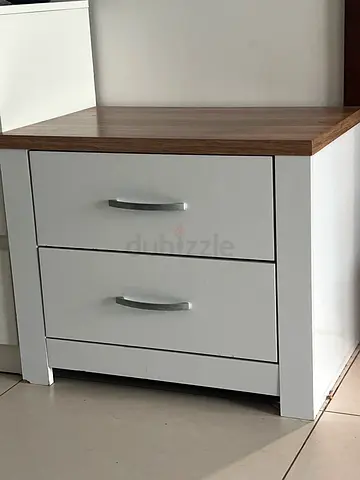 Compact white bedside cabinet with two doors