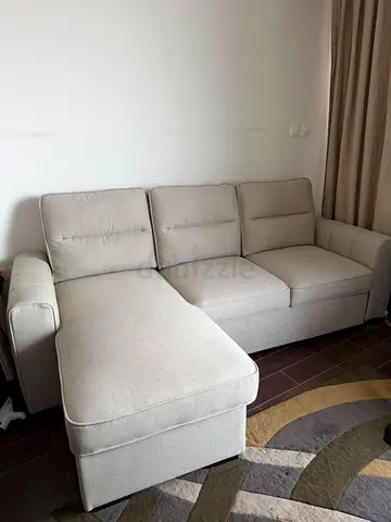 Light beige L-shaped storage sofa with removable ottoman - excellent condition (new)
