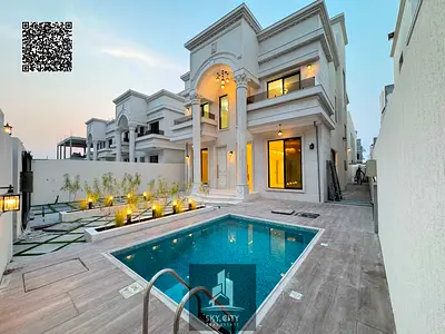 Luxury villas in Ajman with a swimming pool and yard, classic design, central air conditioning, and