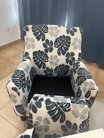 Comfortable floral-patterned armchair with matching footstool