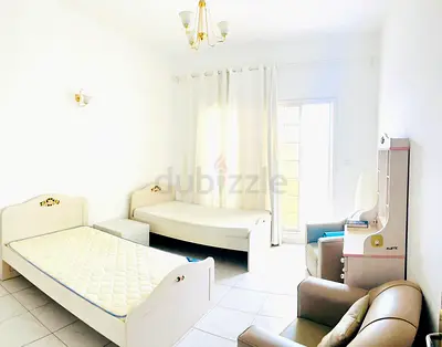 Bright furnished twin bedroom set with beds, mattress and dresser