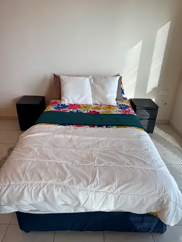 Comfortable Double Bed with Two Black Nightstands