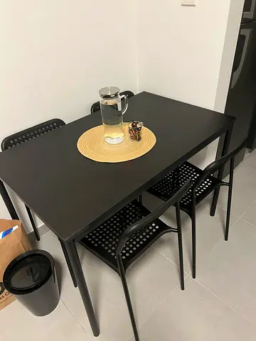 Simple dark wood dining table with 4 matching chairs from IKEA