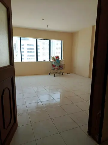 Annual apartment for rent in Al Majaz 1. Three bedrooms, living room, 3 bathrooms, central AC, spacious layout, official bachelor accommodation, prime
