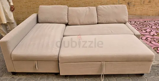 Light beige L-shaped sofa bed with storage - good condition