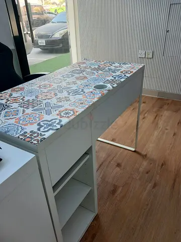 IKEA-style white desk with patterned tile top and storage shelves
