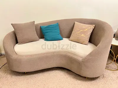 Curved Two-Seater Beige Sofa with Cushions - Modern Design