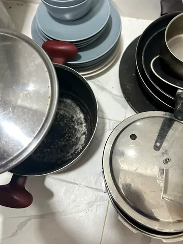 Used set of pots and pans — mixed cookware, some wear