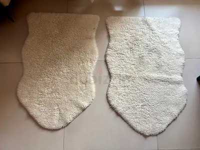 Pair of cream sheepskin-style rugs - soft, used condition