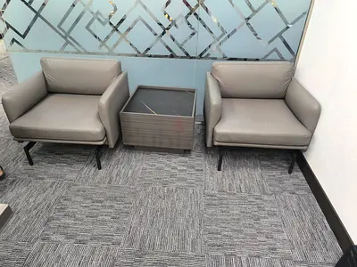 Pure leather Pair of modern grey lounge chairs with matching side table
