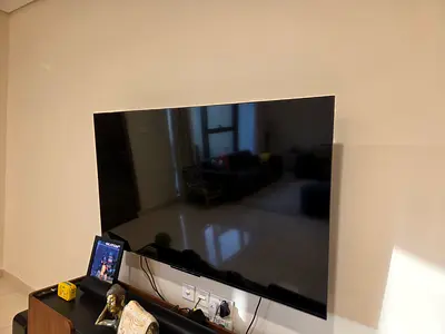 Flat panel smart TV - 65 inch (wall-mounted, good condition) with remote. No issues with TV.