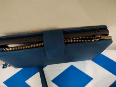 Blue leather-look wristlet wallet with card slots and phone pocket