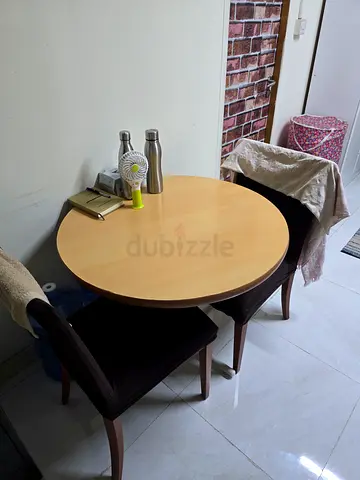 Round wooden dining table with two chairs - good condition