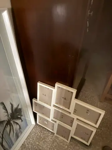 Set of white multi-photo frames and large framed palm print
