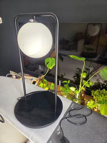 Modern black metal table lamp with frosted globe shade