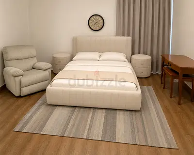 Beige upholstered double bed with matching nightstands - recliner chair and sidetable - complete set