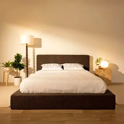 Low platform upholstered queen bed with padded headboard