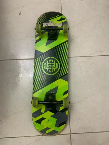 Used green graphic complete skateboard - good working condition