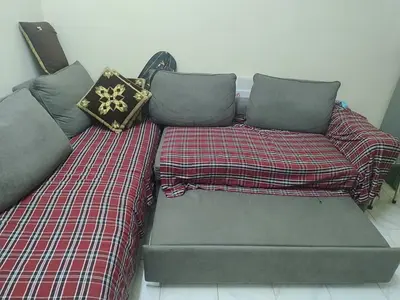 L-shaped grey fabric sofa with ottoman — good condition