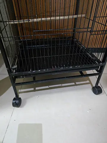 Large black metal bird cage on wheels - good condition for sale..