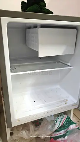 Small single-door mini fridge with freezer compartment - used