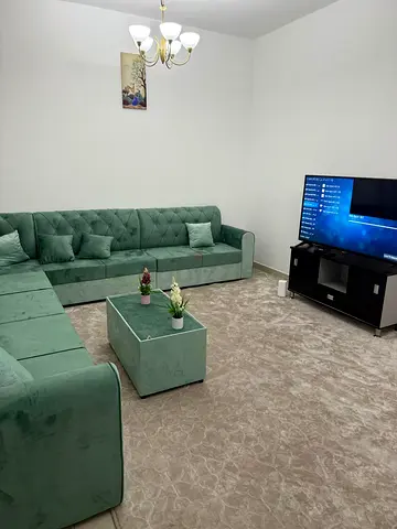 Large Green Velvet L-Shaped Sofa with Matching Ottoman