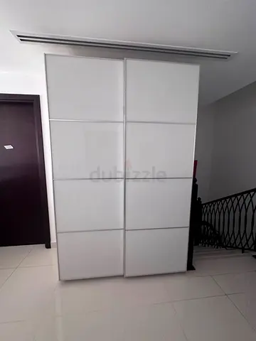 White sliding door wardrobe / armoire in good condition