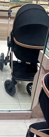 Black pram stroller with gold frame - good condition