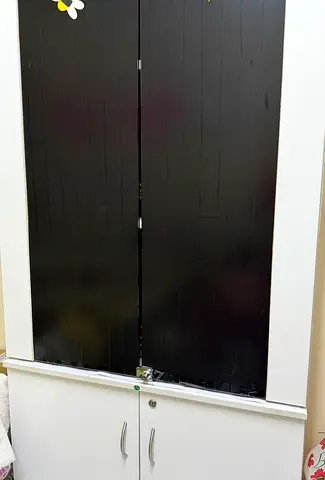 White cabinet with black sliding doors - good condition