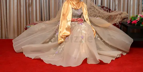 Light champagne/gold tulle overlay base with pastel lilac and green embroidery accents.