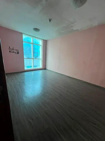 Two-Bedroom Apartment with Living Room, close to Dubai exit, clean tower, and full maintenance.
